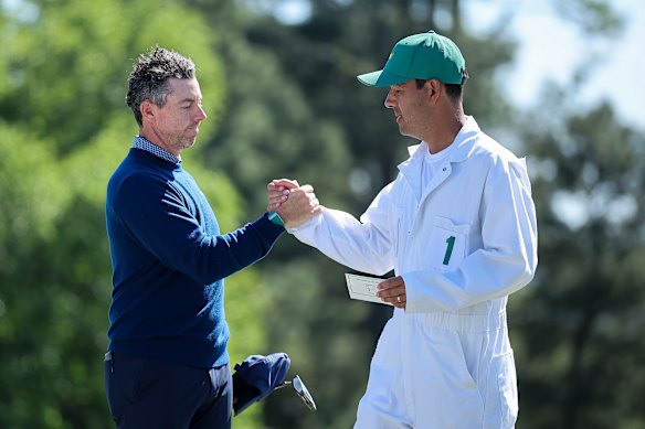 Rory McIlroy and caddie Harry Diamond shake hands on the 18th after the first round of the 2026 Masters.