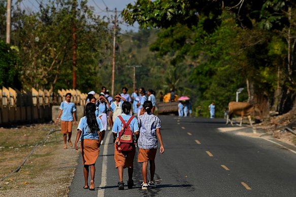 Timorese students walk along the main road in Balibo. In 2024 the government of Timor-Leste launched a single-dose HPV vaccination program for girls aged 11-14 years. Cervical cancer is the second-most common cancer among women in Timor-Leste. 