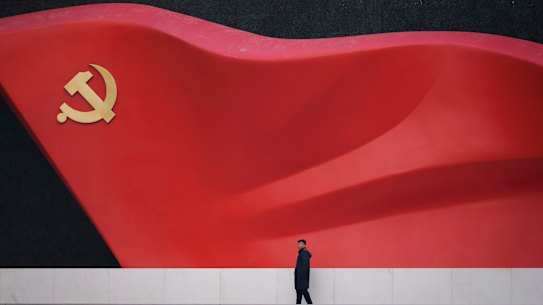 A man walks near a large sculpture of the Communist Party flag at the Chinese Communist Party History Exhibition in Beijing, China.