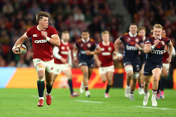 Huw Jones of the British & Irish Lions scores a try after a failed Reds’ chip.