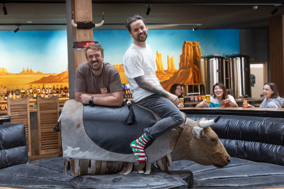 Moon Dog Wild West successful  Footscray, featuring the mechanical bull ridden by owners Josh Uljans (left) and Karl van Buuren.