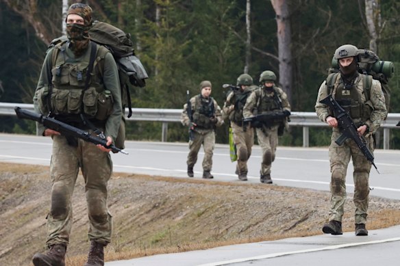 Lithuanian soldiers patrol a road beside a training range near Vilnius earlier this year.