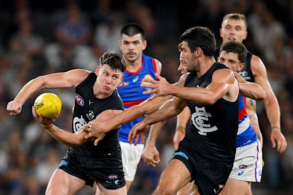 Sam Walsh gets a handball away.