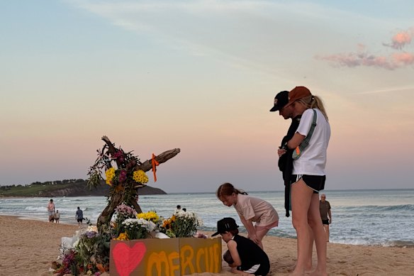Locals pay tribute to Mercury Psillakis at Dee Why Beach. 