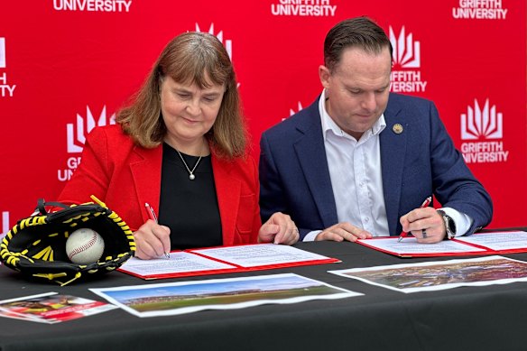 Griffith University vice chancellor Carolyn Evans and Logan Mayor Jon Raven sign a memorandum of understanding to build a baseball and softball stadium at the university’s Logan campus.