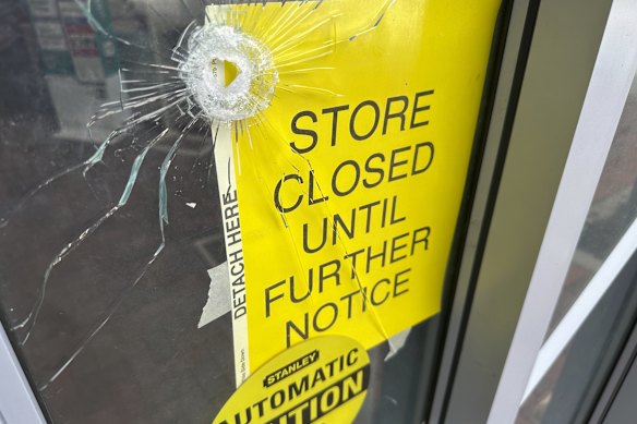 A bullet hole in the door of a pharmacy near where police say a man was shooting at the headquarters of the Centres for Disease Control and Prevention on August 8.