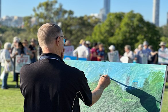 Former deputy mayor David Hinchliffe painting a vista of Victoria Park during Wednesday’s protest.