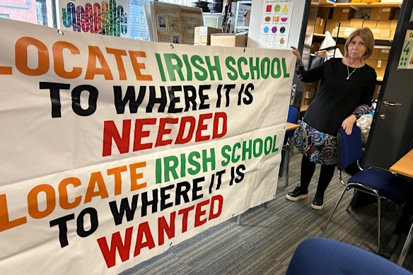 Linda Ervine, an Irish-language advocate in East Belfast, displays one of the protest signs hung outside the Irish school she started in that Loyalist part of the city. 