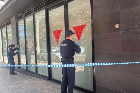 The front of the US consulate in North Sydney was damaged by a sledgehammer and painted with red inverted triangles.