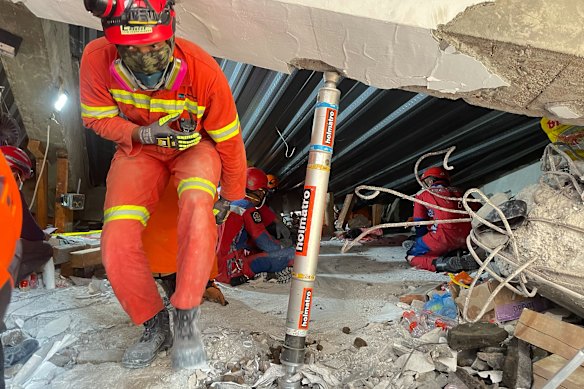 Rescuers search for victims trapped under the rubble.