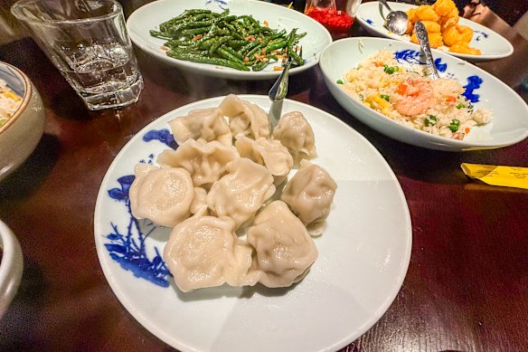 Lunch at New Shanghai is (clockwise from front) chicken and celery dumplings,  string beans with dried shrimp and soy sauce,  wok fried king prawns with salted egg yolk and Yangzhou fried rice.