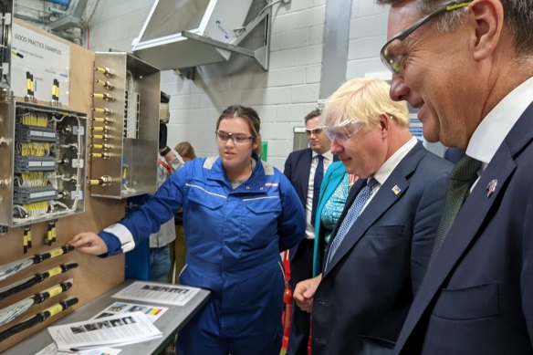 Defence Minister Richard Marles (right) and then-British PM Boris Johnson talk to Autumn Benson, a first-year-apprentice at BAE Systems, at the company’s submarine shipyards in the British port of Barrow-in-Furness in August last year.