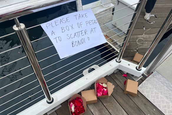 Boxes of roses are left at the start of the dock for race participants to take with them and scatter as the fleet passes Bondi.
