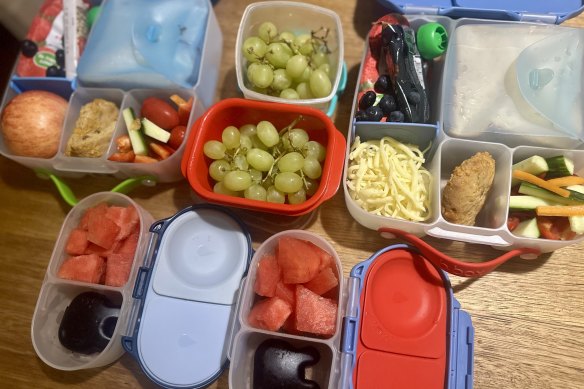 This is far from an Instagram-worthy lunchbox. A classroom fruit snack, morning tea container and a main lunchbox for a kindy kid and a prep child. Sometimes it’s healthier, sometimes not.