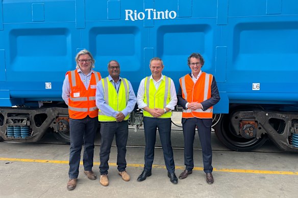 Gemco Rail managing director Dean Draper, Pilbara MP Kevin Michel, Premier Roger Cook and Rio Tinto iron ore boss Simon Trott in front of the new rail car.
