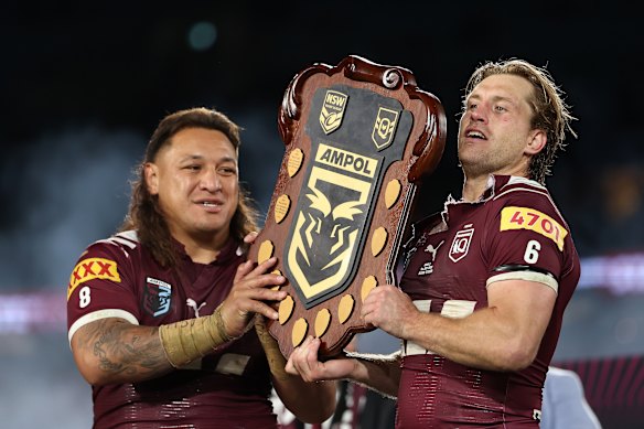 Cameron Munster and Josh Papali’i celebrate Queensland’s series win.