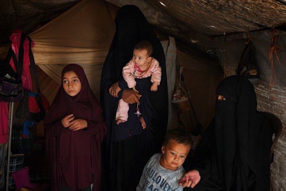  Maysa (left) at age nine with family members in al-Hawl camp in Syria in 2019.