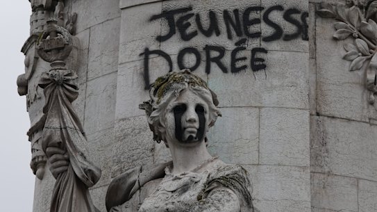Tagging reading “The golden youth” on the statue of Equality at the Republique square, after a quiet night Monday under curfew, the first since weekend protests over the cost of living turned into rioting and looting across France, in Paris, Tuesday, Oct. 20, 2026. (AP Photo/Christophe Ena)