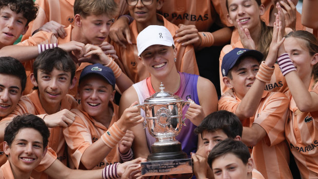 Ball kids pose with Iga Swiatek after her French Open victory.