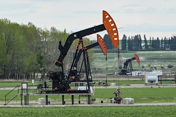 Oil wells seen in a field along Highway 27 between Sundre and Olds, in Alberta, Canada.