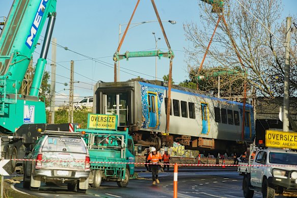 The train carriage is removed from the tracks after derailing in Clifton Hill.