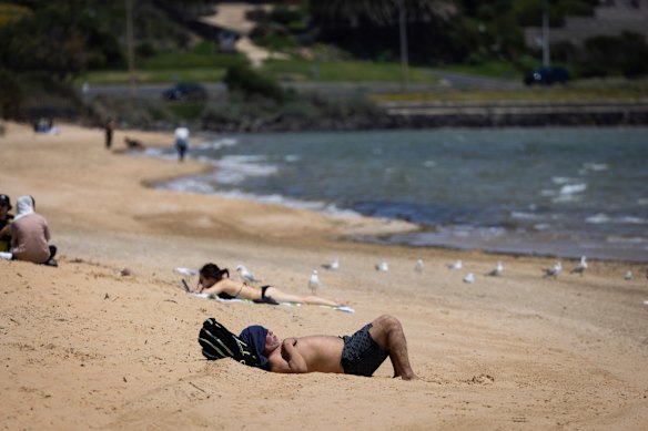 People enjoy the warm weather at  Frankston beach in Melbourne on Friday.