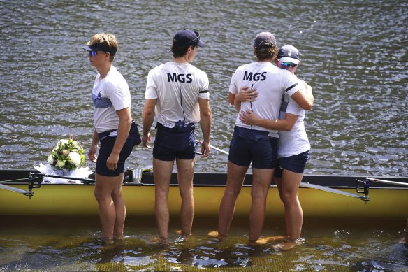 Millear’s teammates embrace each other before doing a memorial “row past” to honour the 17-year-old.