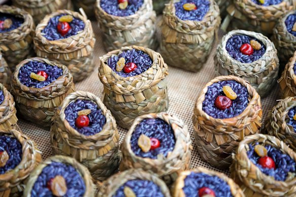 A display of sticky purple rice baskets that are sold as snacks on the streets in Hongcun, China.