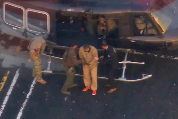 Nicolas Maduro disembarks from a helicopter on his way to court.