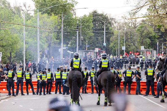 Police form a line between opposing groups of protesters in Melbourne’s CBD on Sunday.