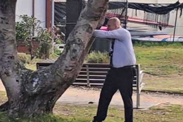 Detective Senior Constable Cesar Barraza – seen here aiming from his position behind Bondi Surf Lifesaving Club – has been identified as the hero police officer who shot Bondi Beach terrorist Sajid Akram.