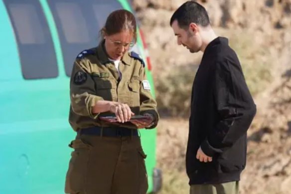 Guy Gilboa-Dala is with an IDF officer following his release.