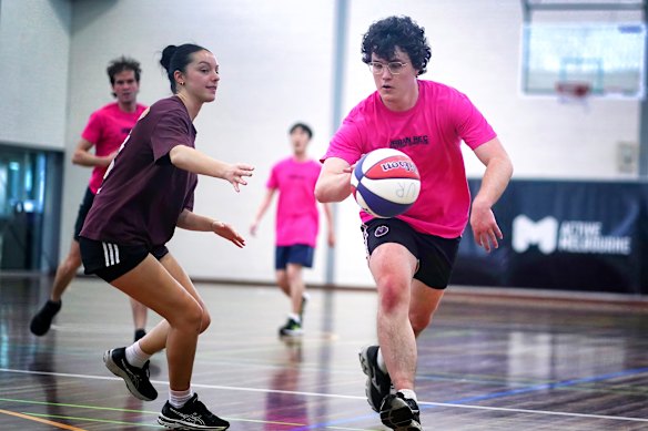  Lachlan Florez (right) plays basketball for the Mystic Flames multisport team.