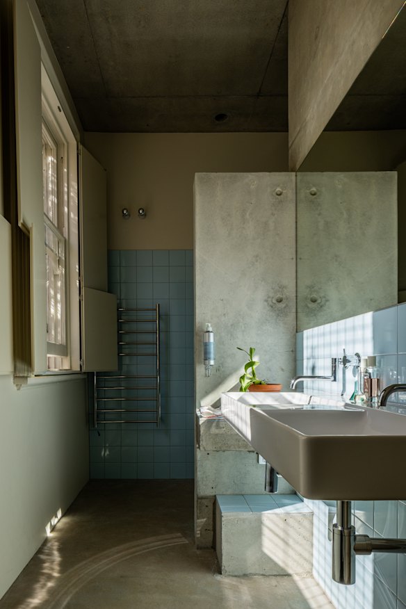 The new bathroom at ground level with D-tiles, in the same duck-egg blue used for the exterior paintwork.