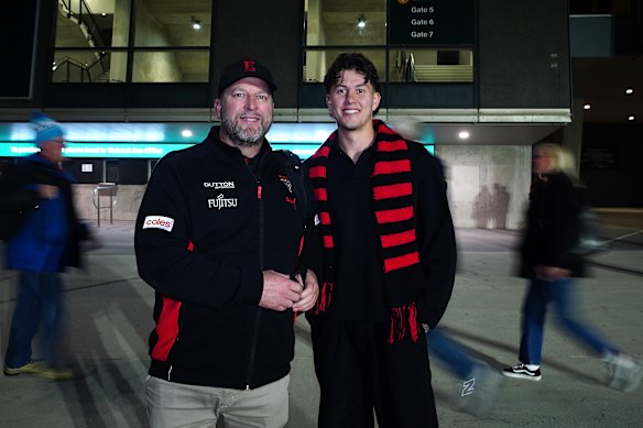 Essendon fan Christopher Klose with his son Jordan outside the MCG.