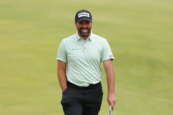  John Parry grins after sinking a hole-in-one.