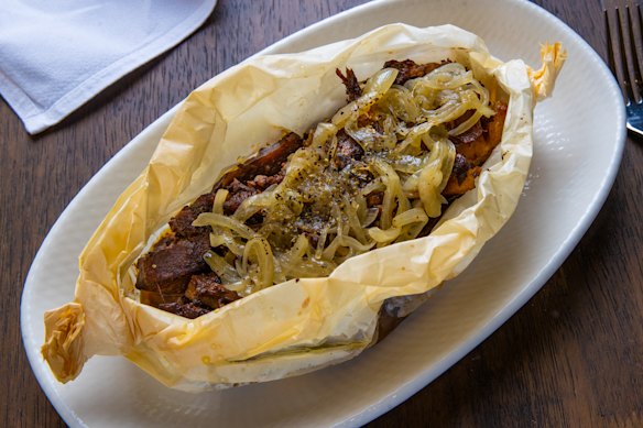 Goat is baked in the oven in parchment paper.