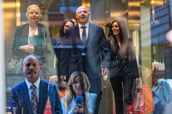 Reporters are seen in a reflection as Tony Mokbel walks free from the Melbourne Supreme Court.