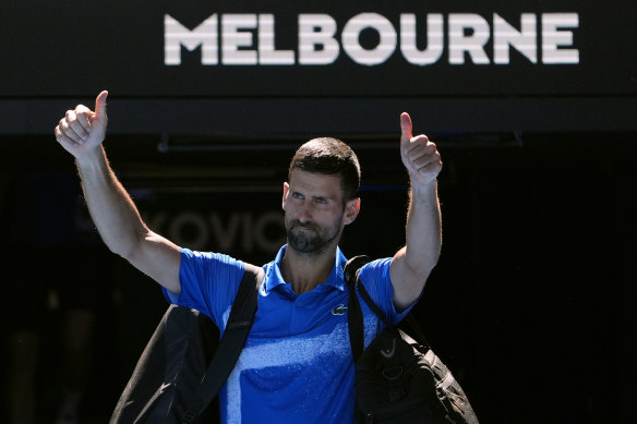 Novak Djokovic gestures to the crowd as he walks off Rod Laver Arena for the final time in 2025.