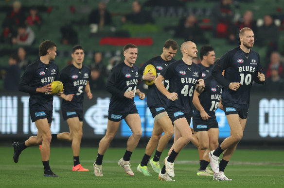 Carlton players warm up before tonight’s crucial clash against Melbourne.