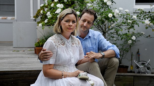 Elouise and Danny Massa holding a pair of their son Joe’s shoes.