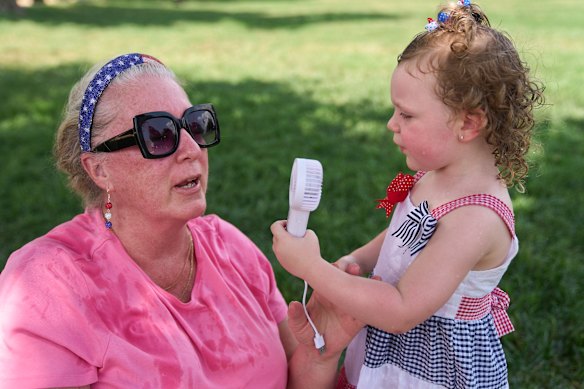 Colleen Richman is fanned by her granddaughter, Everlee Twyman, 2, at the fair.