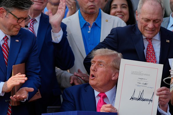 President Donald Trump signs his signature bill into law.