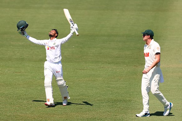 Cummins looks on as Tanzid Hasan of Bangladesh celebrates his century.