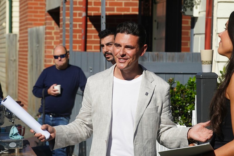 Whitefox chief executive Marty Fox auctions 6 Gray Lane, Albert Park. Vendor Danny Wallis watches on, coffee in hand.