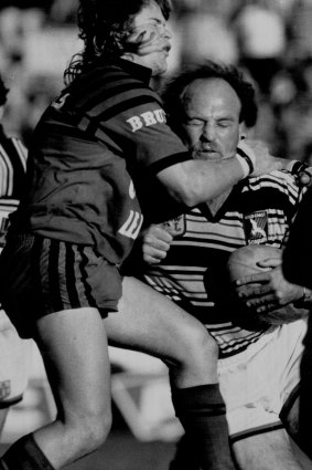 Wally Lewis is tackled during a game in August 1991.