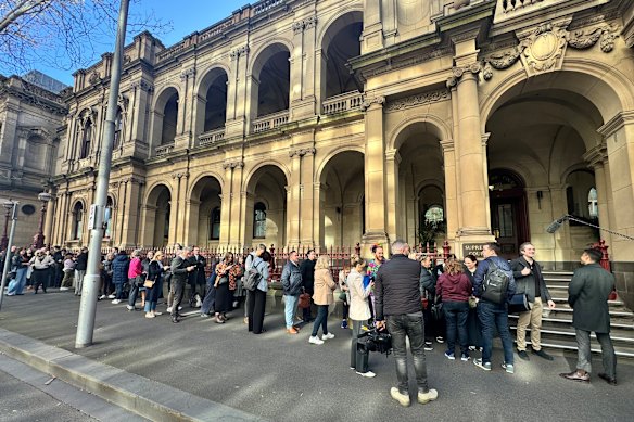 Reporters and interested onlookers queue outside the Supreme Court of Victoria for her sentencing.