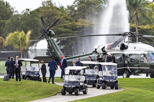 President Donald Trump disembarks Marine One on the ninth hole during previews for LIV Golf Miami at Trump National Doral, Miami.