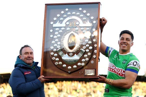 Raiders coach Ricky Stuart and captain Joseph Tapine pose with the JJ Giltinan Shield after winning the minor premiership.