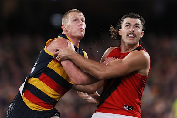 New teammates? Sam Draper of the Bombers competes with Adelaide’s Reilly O’Brien.